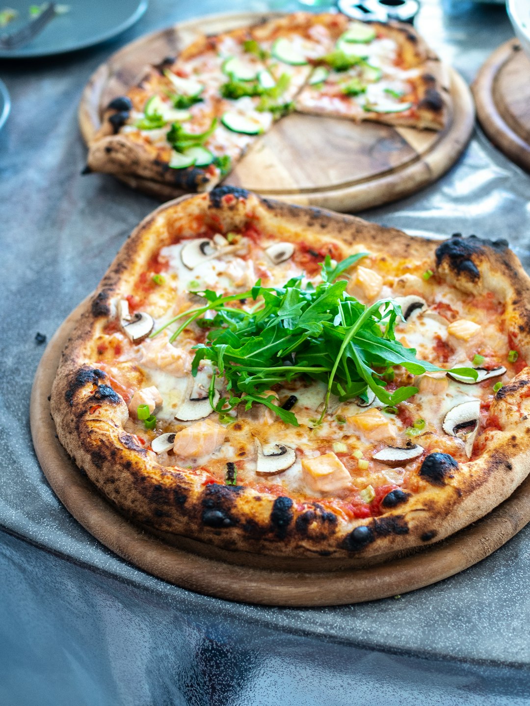 Various pizza toppings arranged on a wooden board